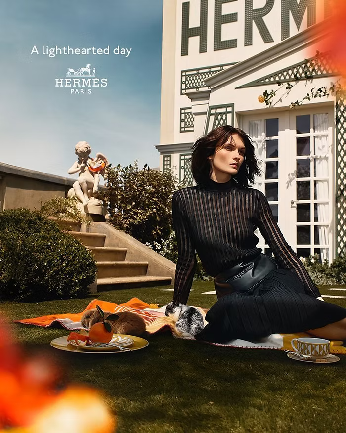 A female model wearing black outfit for a Hermès Paris campaign