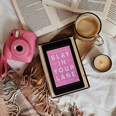 Pink polaroid camera and pink book cover on a kindle
