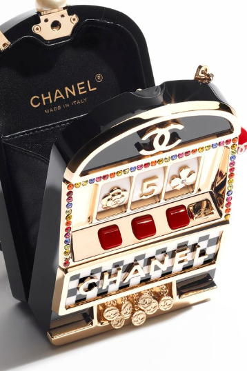  Chanel clutch designed to look like a slot machine, featuring metallic details and colorful embellishments.