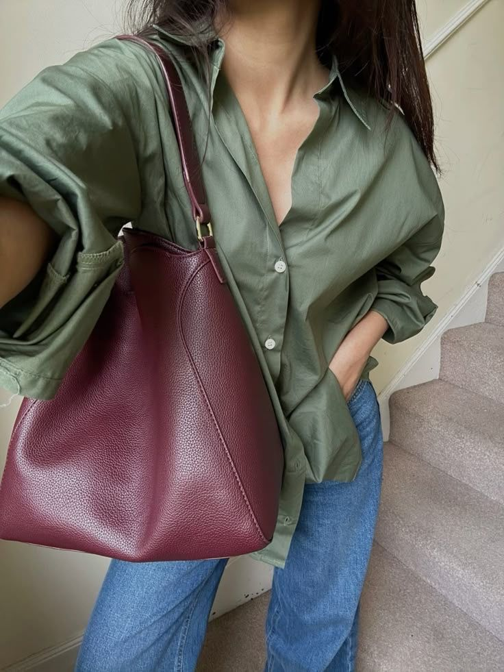 olive green shirt, burgundy bag and denim jeans